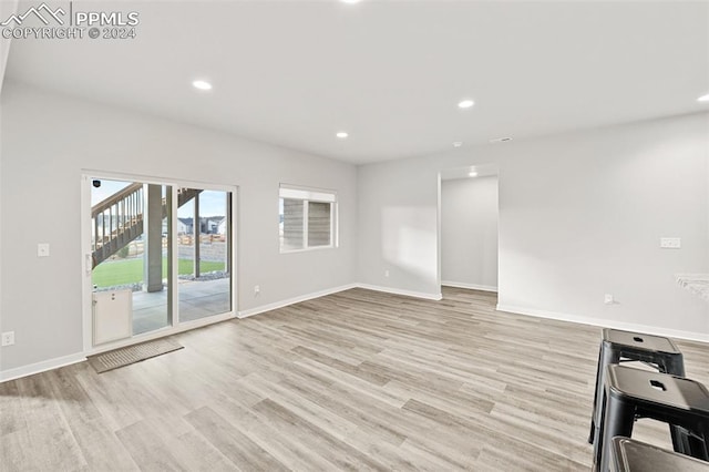 unfurnished living room with light hardwood / wood-style flooring