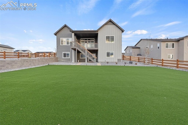 rear view of property with a lawn and a deck