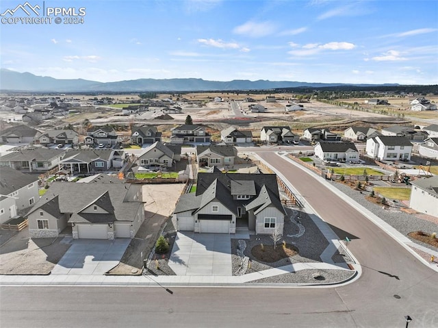 birds eye view of property with a mountain view