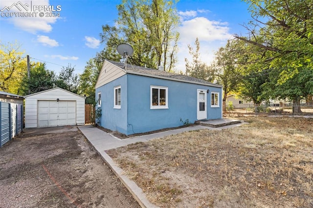 view of front of home with an outdoor structure and a garage