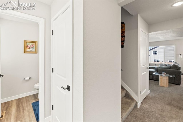 hallway with hardwood / wood-style flooring