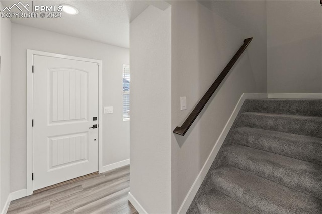 foyer entrance with light wood-type flooring