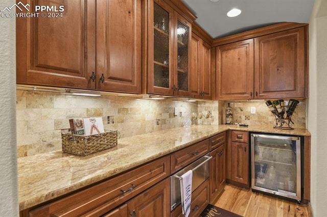bar with a warming drawer, light wood-style floors, tasteful backsplash, and wine cooler