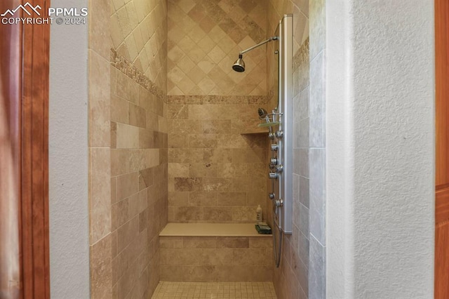 bathroom with a tile shower