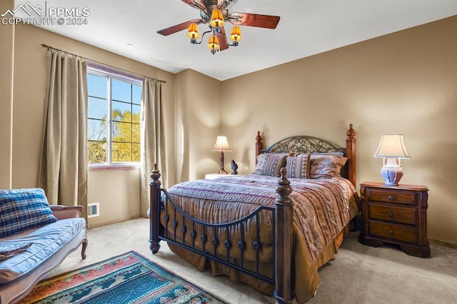 carpeted bedroom with ceiling fan and visible vents