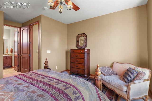 tiled bedroom featuring ensuite bathroom and ceiling fan