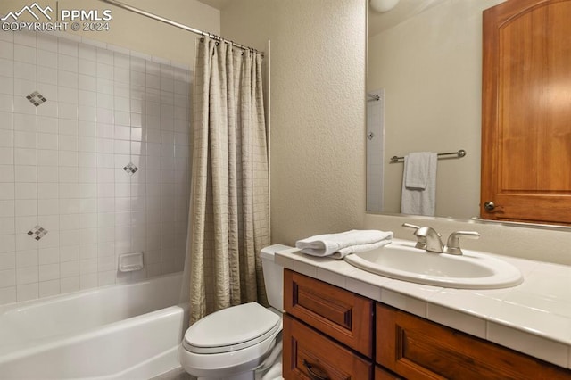 full bathroom with a textured wall, toilet, vanity, and shower / bath combination with curtain