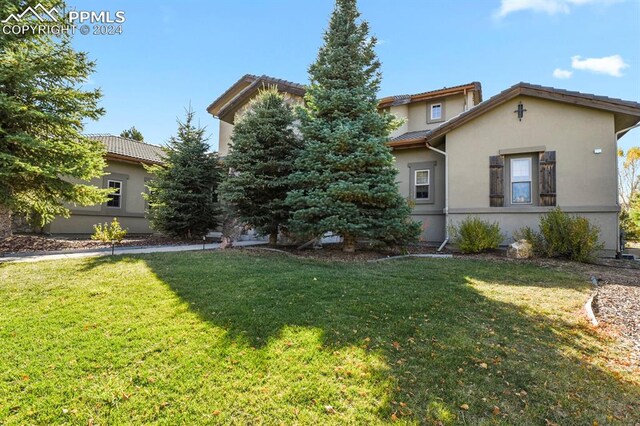 mediterranean / spanish home with a front lawn