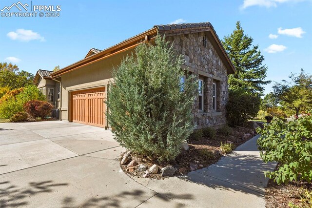 view of side of home featuring a garage