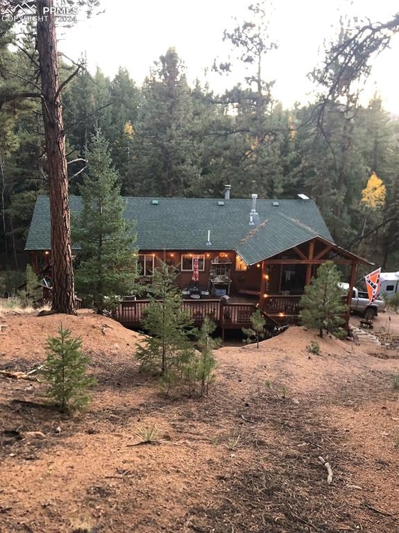 back of house with a wooden deck