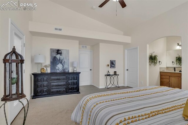 carpeted bedroom with lofted ceiling, ensuite bath, and ceiling fan