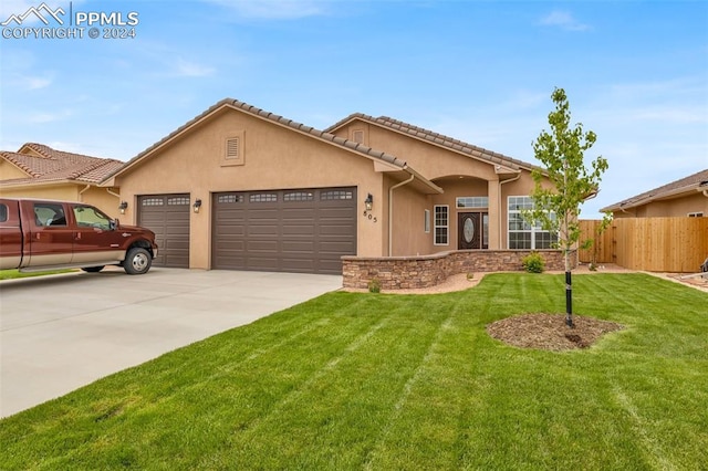 view of front facade with a garage and a front lawn