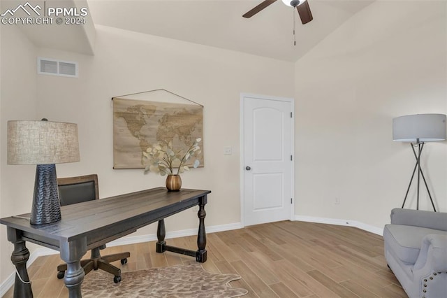 office area featuring light hardwood / wood-style floors, ceiling fan, and vaulted ceiling