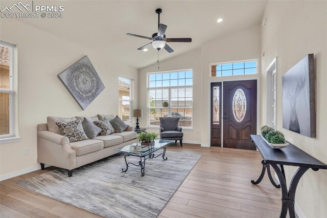 living room with high vaulted ceiling, light wood-type flooring, and ceiling fan