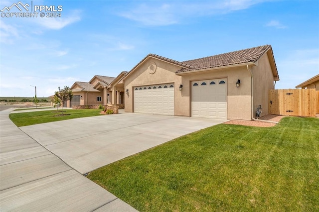 view of front of house with a front yard and a garage