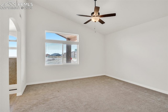 unfurnished room featuring lofted ceiling, light colored carpet, and ceiling fan