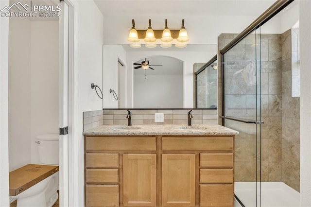 bathroom featuring vanity, toilet, and walk in shower