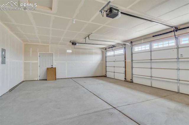 garage featuring a garage door opener and electric panel