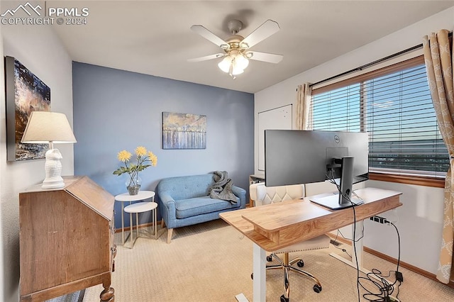 office space featuring light carpet and ceiling fan