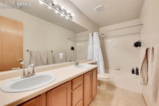 full bathroom with vanity, shower / tub combo with curtain, and toilet