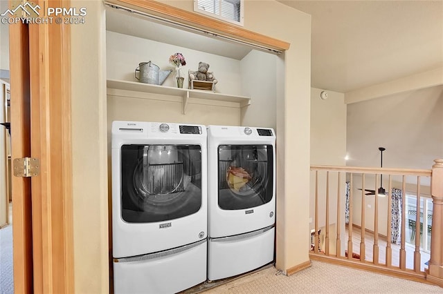 clothes washing area with ceiling fan, washing machine and clothes dryer, and carpet flooring