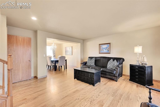 living room featuring an inviting chandelier and light wood-type flooring