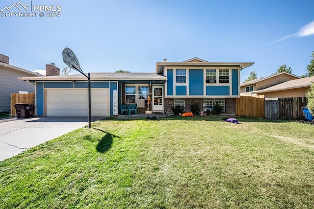 split level home with a garage and a front lawn