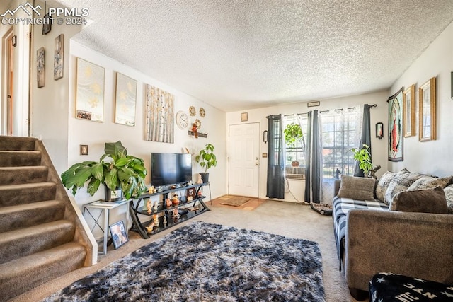 carpeted living room featuring a textured ceiling