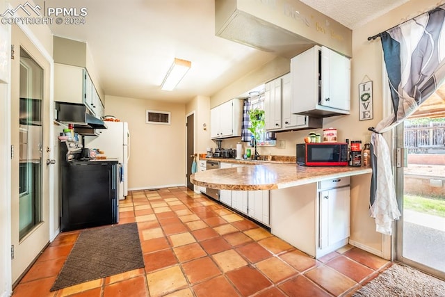 kitchen featuring white cabinets, black appliances, sink, and light tile patterned floors