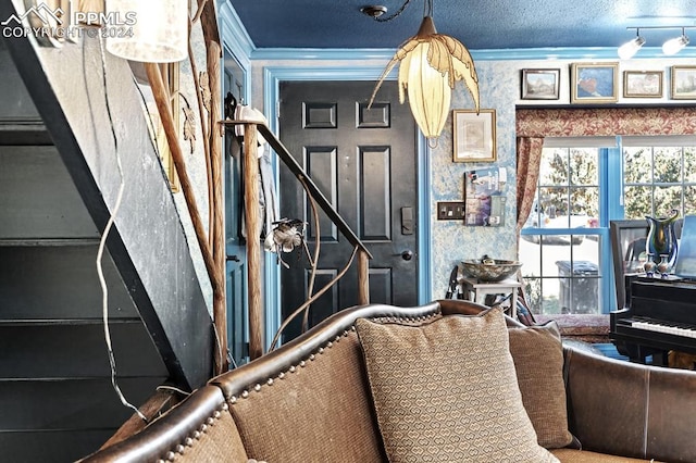 interior space featuring ornamental molding and a textured ceiling