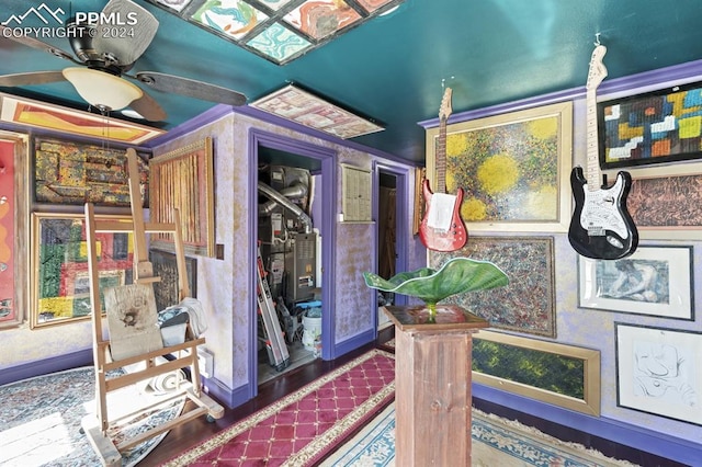 interior space with wood-type flooring and ceiling fan