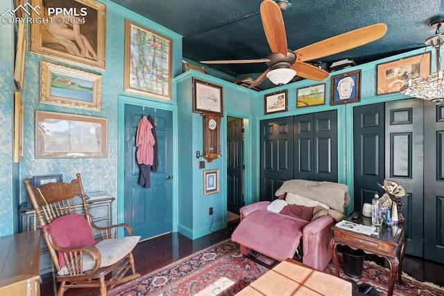 sitting room featuring wood-type flooring and ceiling fan