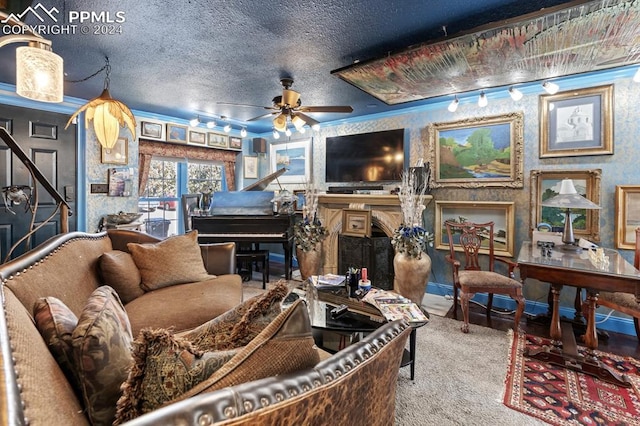 living room featuring ceiling fan, rail lighting, a textured ceiling, carpet flooring, and a fireplace