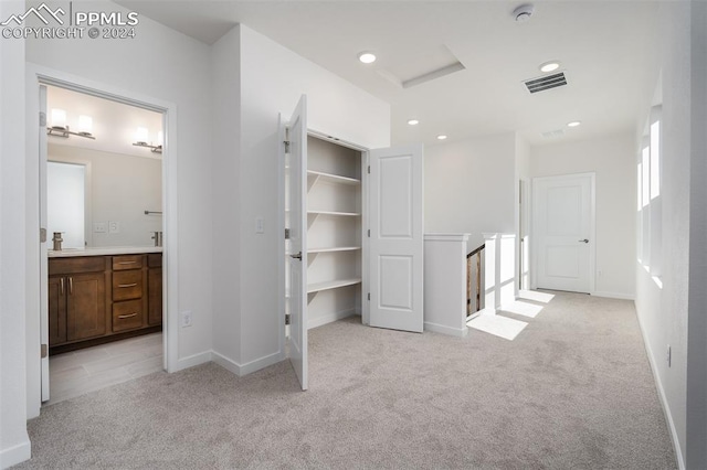 interior space featuring light carpet and sink