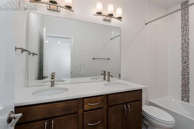 full bathroom with vanity, toilet, and tiled shower / bath combo