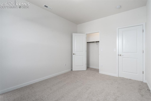 unfurnished bedroom with light carpet