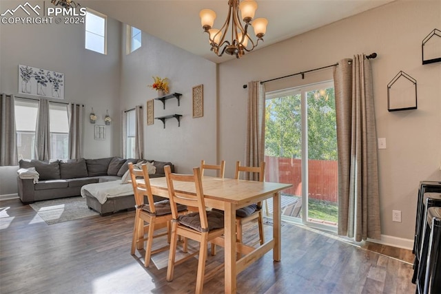 dining area with an inviting chandelier and dark hardwood / wood-style flooring