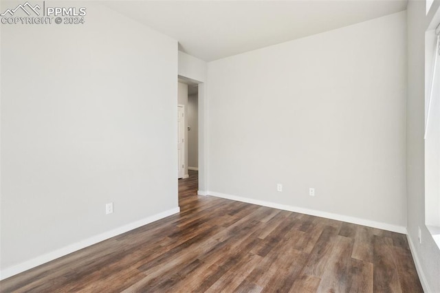 empty room featuring dark wood-type flooring