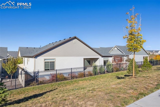 view of side of property with a lawn