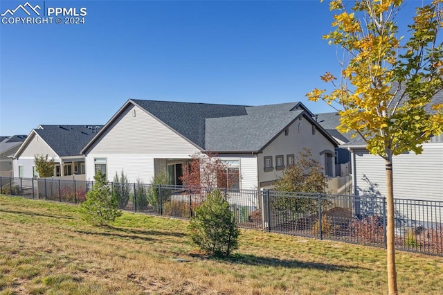 rear view of property featuring a yard