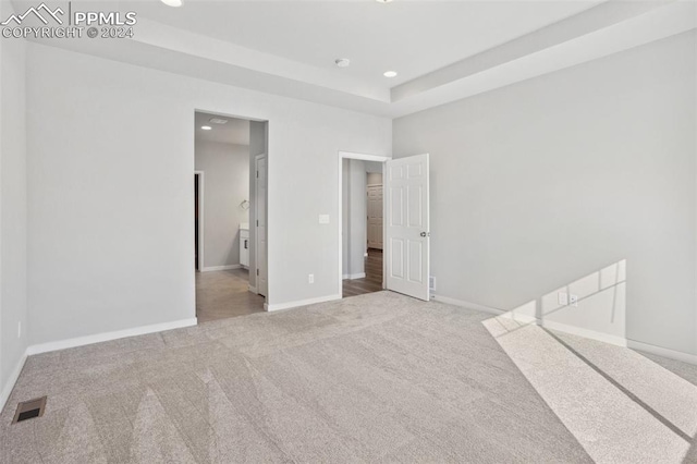 unfurnished bedroom with connected bathroom and carpet flooring