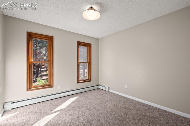 unfurnished room with a textured ceiling, a baseboard radiator, and carpet floors