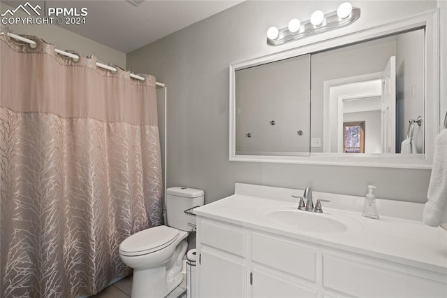 bathroom with vanity, toilet, a shower with curtain, and tile patterned flooring