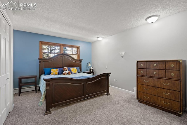 bedroom with a textured ceiling, a baseboard heating unit, light colored carpet, and a closet