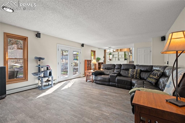 living room with hardwood / wood-style floors, a textured ceiling, french doors, and ceiling fan