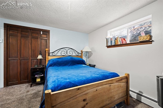 bedroom featuring a textured ceiling, carpet floors, and baseboard heating