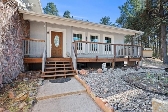 doorway to property featuring covered porch