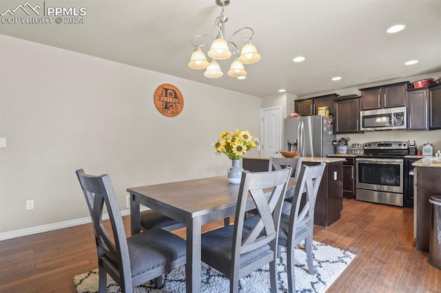 dining room featuring a notable chandelier and dark hardwood / wood-style floors