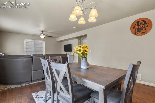 dining area with dark hardwood / wood-style floors and ceiling fan with notable chandelier