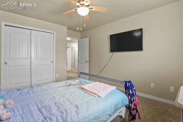 carpeted bedroom with a closet and ceiling fan